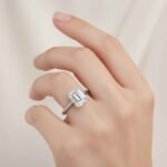 Emerald cut 6 carat lab diamond solitaire ring in 18K yellow gold – front view on matte background