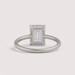 Emerald cut 6 carat lab diamond solitaire ring in 18K yellow gold – front view on matte background