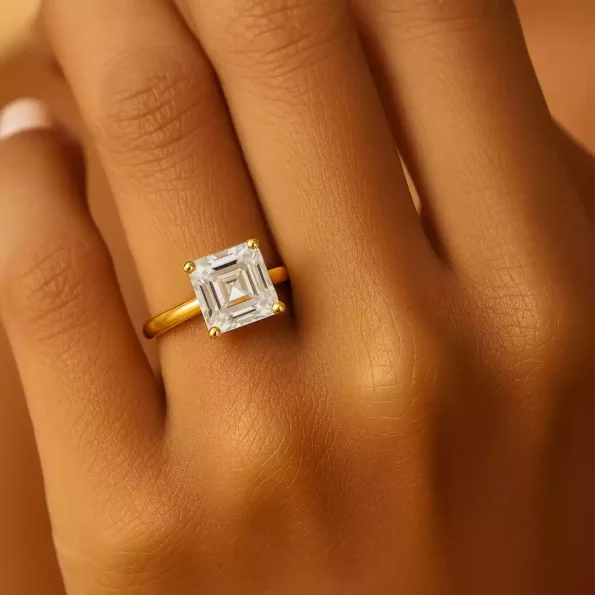 Close-up of hand wearing 5ct Asscher cut lab diamond solitaire ring in yellow gold – bold and elegant engagement ring
