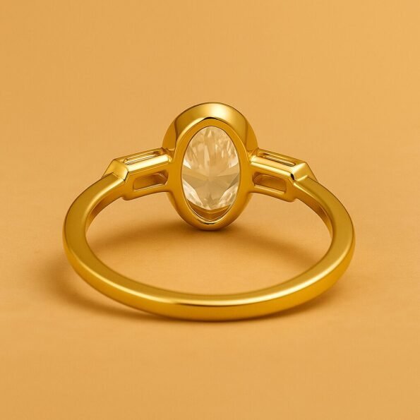 Back view of oval cut diamond ring with tapered baguette side stones in yellow gold setting