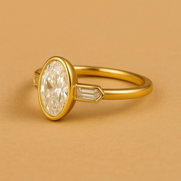 Front view of oval diamond three-stone engagement ring in yellow gold with bezel setting