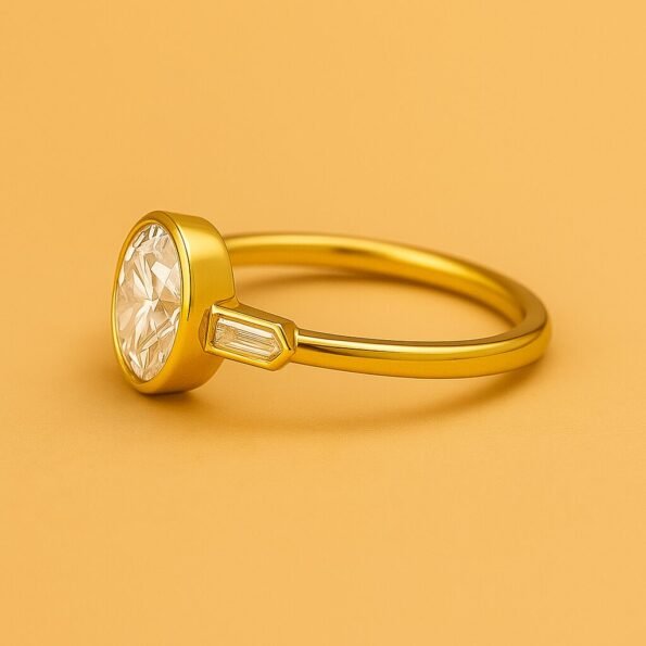 Side profile of round diamond ring in yellow gold with bezel setting and baguette diamond accents