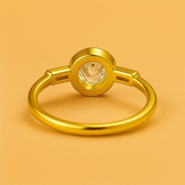 Back view of round cut diamond ring in yellow gold bezel setting with tapered baguette side stones
