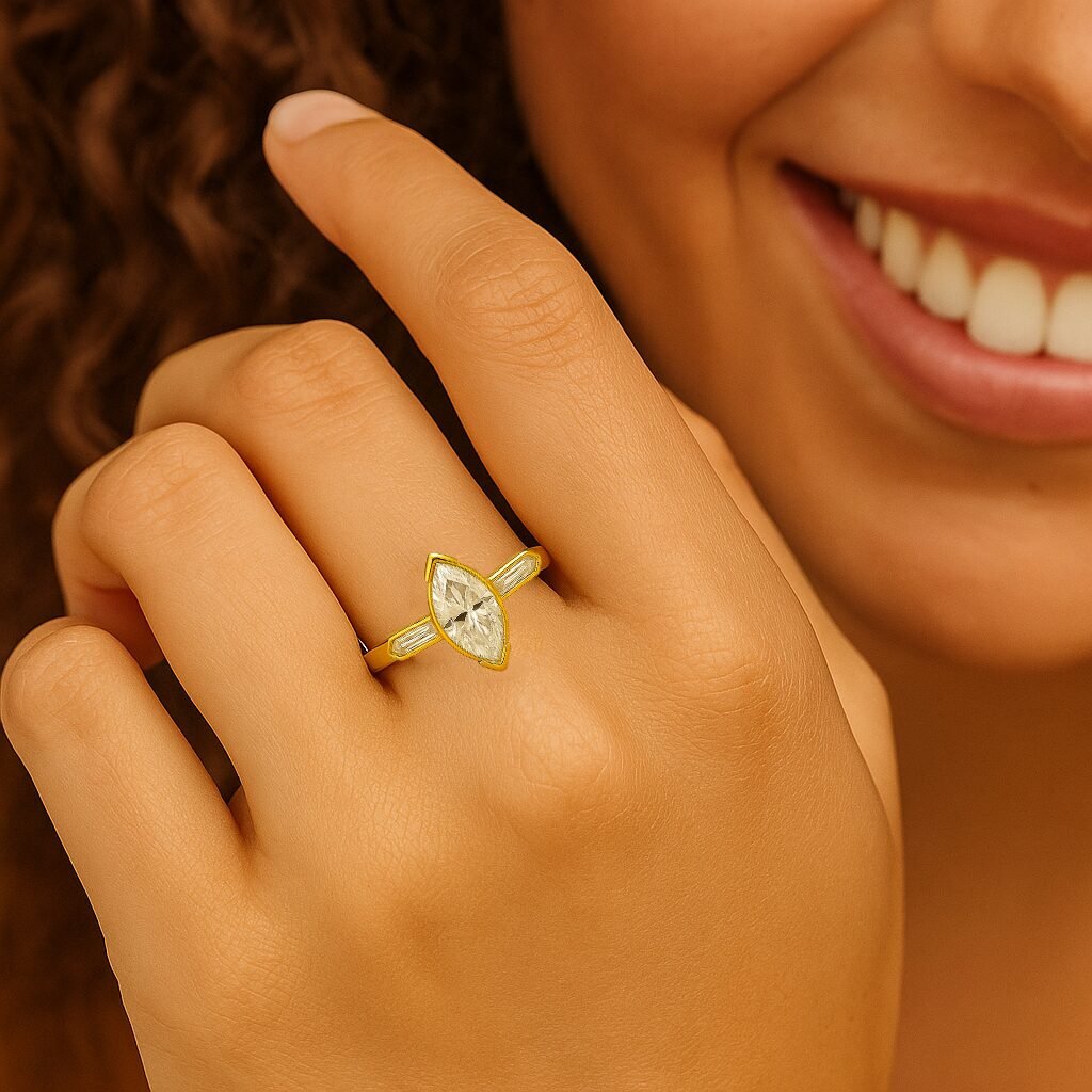 UN1016 (1) Marquise cut diamond engagement ring in yellow gold worn on a woman's hand