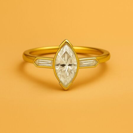 Front view of marquise cut three-stone diamond ring with tapered baguettes in yellow gold