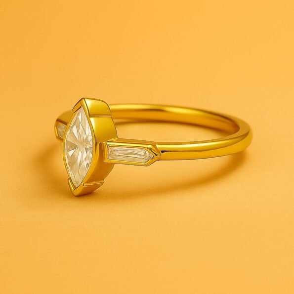 Side view of marquise cut diamond ring in yellow gold with tapered baguette accents
