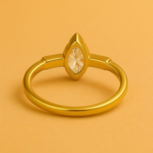 Back view of yellow gold ring featuring marquise cut center diamond in bezel setting