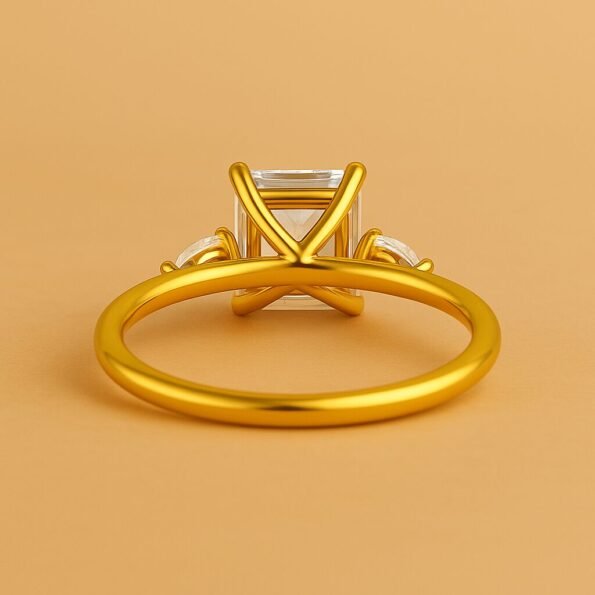 Underside of princess cut diamond engagement ring in yellow gold, featuring an open gallery and prong setting.