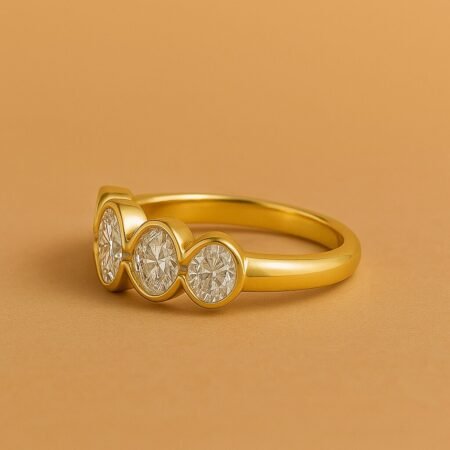 Side angle of a five-stone bezel-set diamond band in yellow gold showcasing modern symmetry and clean finish.