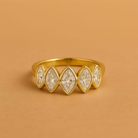 Front view of marquise cut lab diamond band ring with five bezel-set stones in polished yellow gold.