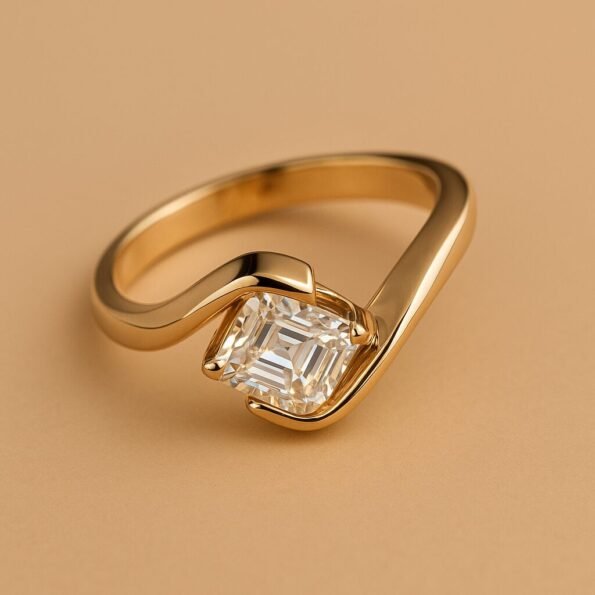 Close-up of bypass solitaire ring featuring an Asscher cut diamond set in 18K yellow gold