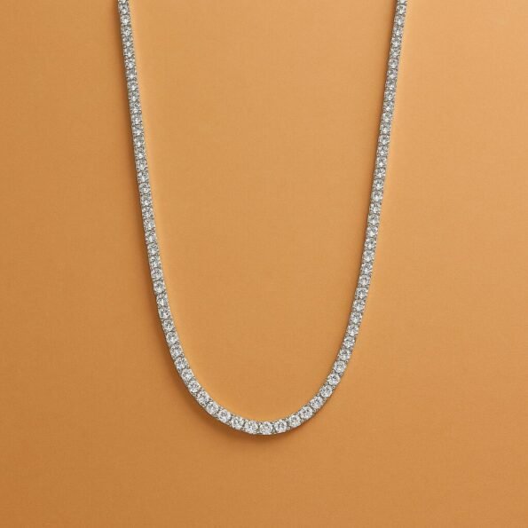 Full view of long lab-grown diamond tennis necklace in white gold – flat lay on neutral background