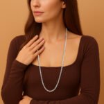 Woman wearing long lab-grown diamond tennis necklace in white gold – elegant chest-up fashion close-up