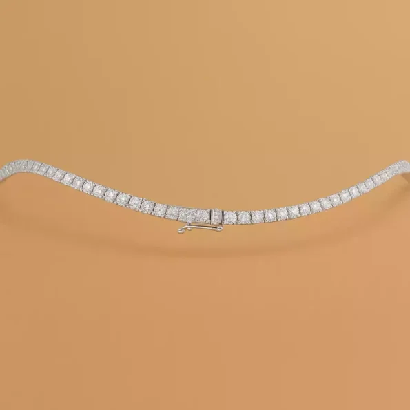 Round cut lab-grown diamond tennis necklace in white gold with secure clasp – flat layout on neutral background