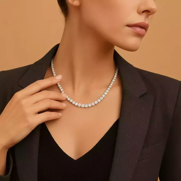 Woman wearing round diamond tennis necklace in white gold with formal black blazer – close-up chest view
