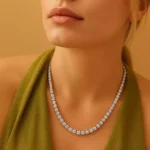 Close-up of woman in green dress wearing round lab-grown diamond tennis necklace – luxury evening style