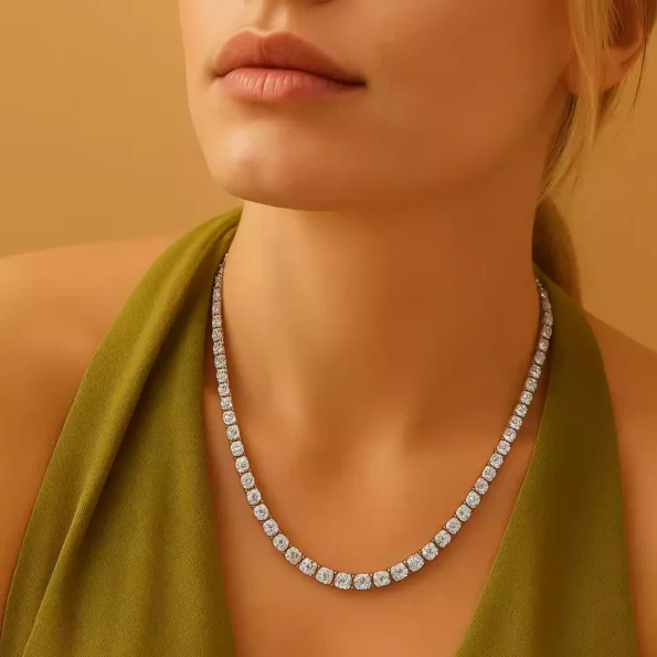 Close-up of woman in green dress wearing round lab-grown diamond tennis necklace – luxury evening style