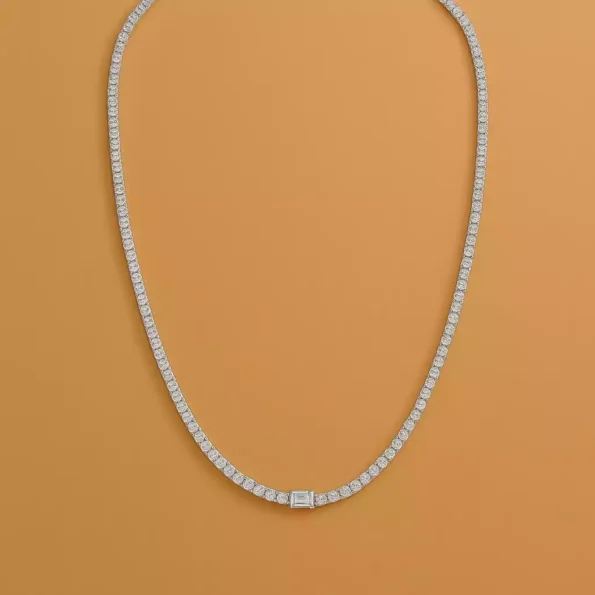 White gold tennis necklace featuring round lab-grown diamonds and center emerald-cut diamond – full top-down view